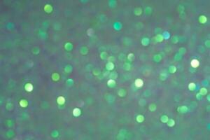 Sparkles defocus light. Glitter paper defocus as background. Green background with defocus. photo