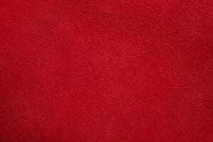 Red suede texture. Red background of natural dyed suede macro. photo