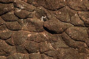 Brown rock texture in top view serves as a unique and captivating.  Nature from top of hill. photo