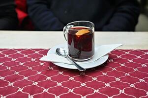 A cup of mulled wine with a shot. Perfect on a cold winter day in Germany photo