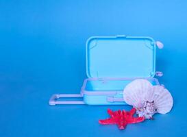 Fully opened blue suitcase, on a blue background, top view. Vacation, travel concept. copy space photo