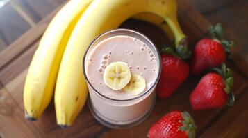 AI generated Banana smoothie in a glass with banana and strawberries lying next to it photo