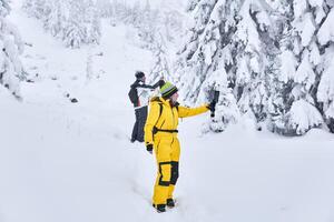 couple of travelers in a winter mountain forest take a selfie against the backdrop of the landscape photo