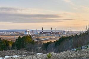 industrial landscape in early spring with a power station in the valley photo