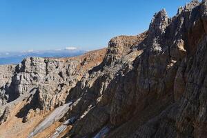 glaciers survived until the end of summer in the shade of rocks on the north side of the Oshten mountain peak in the Caucasus photo