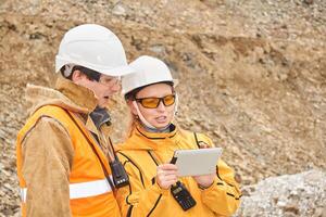 mining engineers discussing working documentation at the mining site photo