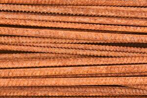 background - pieces of rusty rebar piled in a heap close-up photo