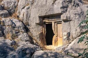 misterioso oscuro Entrada a un antiguo Roca tumba, tallado dentro el roca, en myra licio ahora demré, Turquía foto