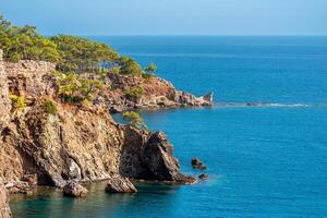 Mediterranean seascape with steep wooded coast photo