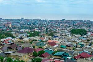 top view from the wall of the citadel to the historical center of the city of Derbent and the Caspian Sea photo