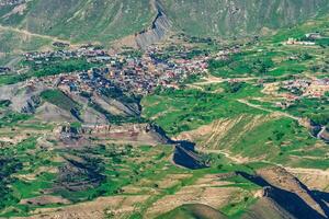 view of the mountain village of Chokh in Dagestan on the slope of a vast valley photo