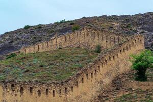 medieval fortress wall on a mountain slope, photo