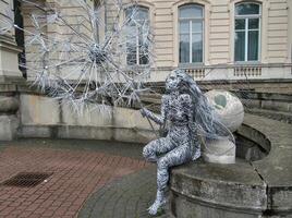 Metal installation of a fairy with a large dandelion flower photo