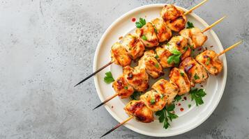 AI generated Chicken kebab skewers on a plate over light grey slate, stone or concrete background . Top view with copy space. photo