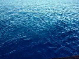 Beautiful rich blue texture of the sea with small waves photo