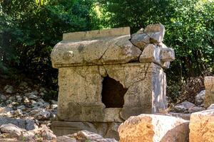 ancient sarcophagus in the ruins of the antique city of Olympos, Turkey photo