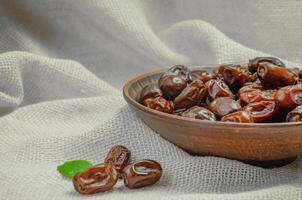 dried dates in a brown ceramic plate photo