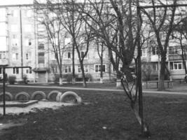 Retro black and white photo of a city yard with an apartment building