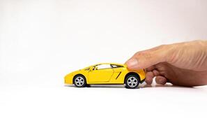 Hand holding a toy car isolated on white background. After some edits. photo