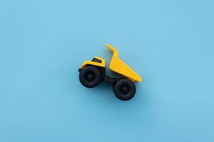 A dump truck miniature isolated on blue background. After some edits. photo