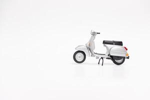 Miniature classic scooter on white background. After some edits. photo