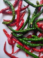 Natural spicy red and green chilies. Organic fresh chili peppers isolated on white. photo