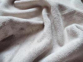 texture, pattern, background of dirty white towel exposed to sunlight photo