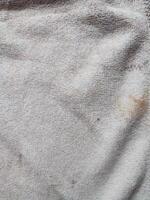 texture, pattern, background of dirty white towel exposed to sunlight photo