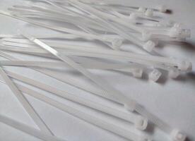 White plastic cable ties isolated on a white background photo