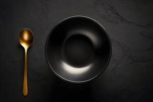 AI generated Empty black bowl with spoon on a dark background from top view photo