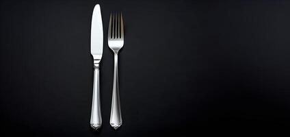 AI generated Fork and knife are presented on a dark background from top view representing cutlery photo