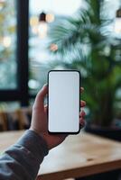 ai generado un del hombre mano participación un teléfono inteligente en moderno oficina con blanco blanco pantalla, primero persona ver foto