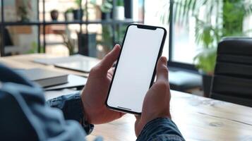 AI generated A man's hand holding a smartphone in modern office with white blank screen, First person view photo