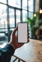 ai generado un del hombre mano participación un teléfono inteligente en moderno oficina con blanco blanco pantalla, primero persona ver foto