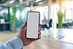 AI generated A man's hand holding a smartphone in modern office with white blank screen, First person view photo