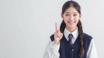 ai generado contento bonito asiático estudiante niña en colegio uniforme señalando dedo arriba aislado en blanco antecedentes. foto