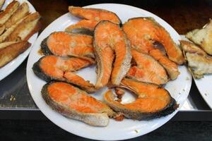 fried fish on the counter. fresh and delicious salmon photo