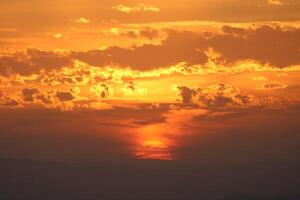 Setting Sun under the clouds. Amazing Sunset incredible sky photo