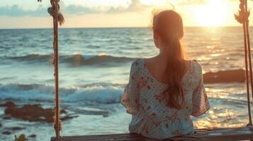 AI generated Rear view image of a young woman sitting on wooden swing by the sea photo