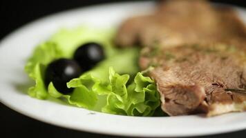 boiled beef tongue sliced in a plate boiled beef tongue sliced in a plate on black background video