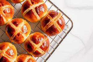 AI generated Traditional Easter hot cross buns on a cooling rack. AI generated photo