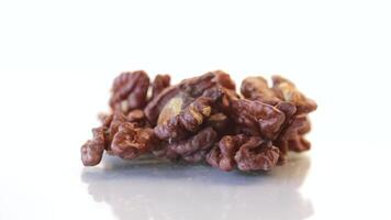 handful of peeled walnuts isolated on white background video