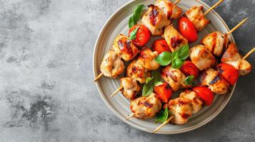 AI generated Chicken kebab skewers on a plate over light grey slate, stone or concrete background . Top view with copy space. photo