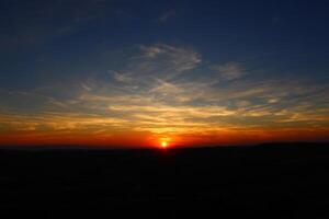 Cumulus clouds and different color tones in the sky at sunset. Amazing and incredible sunset. photo