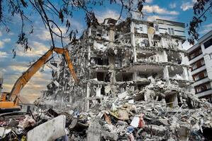 Buildings collapsed after the earthquake. Vehicles working after the earthquake. photo