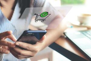 Online shopping and online payments can be done anywhere, anytime. Woman typing text message on smart phone in a cafe photo