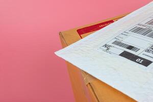 Parcel boxes are shipped by shipping companies on a bright pink background. photo