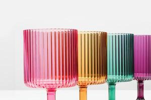 Multi Coloered Wine Glasses on a White Shelf photo