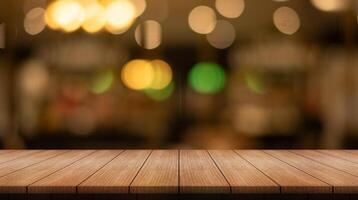 Empty wooden table top with lights bokeh on blur restaurant background. photo