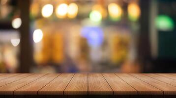 Empty wooden table top with lights bokeh on blur restaurant background. photo